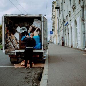 a man unloading furniture from the back of a moving truck